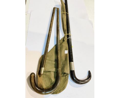 A painted metal walking stick containing a camera tripod, 89cm, and a folding walking stick in canvas case (2).
