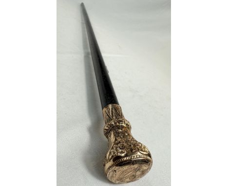 A 19th Century ebonised walking stick with gilt metal floral engraved finial, 81cm.