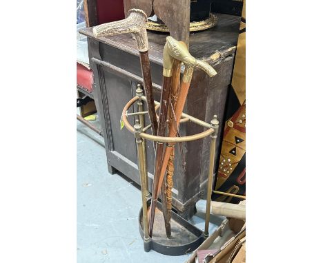A brass demi-lune stick stand, an antler handle walking stick and 3 other novelty sticks.