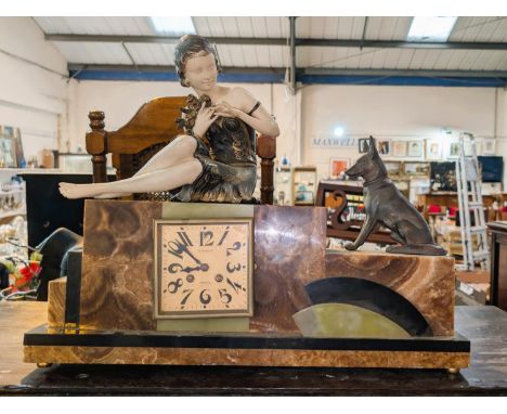 An Art Deco French mantel clock with painted spelter figure of woman and dog.
