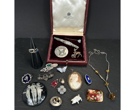 A collection of antique white metal, silver, enamel and other brooches and jewellery.