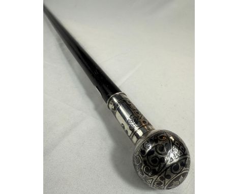 A 19th Century Russian ebonised walking stick with 84 standard silver globe and shaft and decorated in scrolled niello work, 