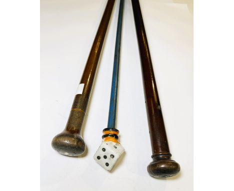 A painted walking stick with porcelain dice finial, 90cm, and two others (3).