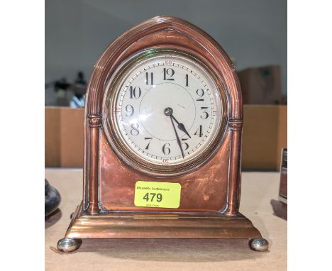A French copper mantel clock with enamel dial.