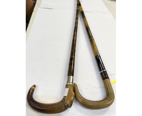 An early 20th Century horn sectional stick with silver mount, 90cm, and another similar (2).