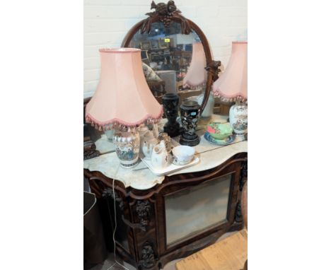 A Victorian simulated zebra wood mirror back chiffonier, the raised oval back with carved fruit and leaves, the serpentine ba