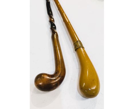 An unusual early 20th Century celluloid stick, 92cm, and another of twisted form (2).