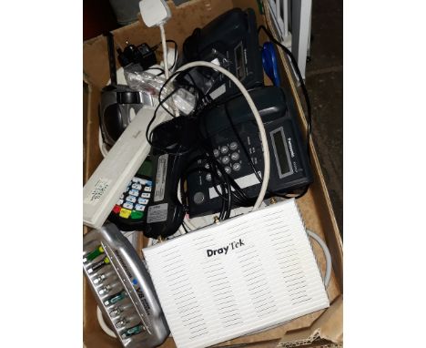 A box of misc imcluding router, battery charger, cable extensions, house phones, stapler, etc 