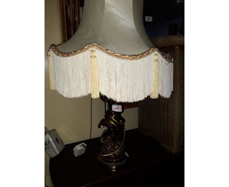 A gilt metal figure table lamp with shade 