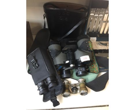 A pair of Leica Trinovid 10 x 25 binoculars, another pair of binoculars, opera glasses and a Minolta camera.See our website c