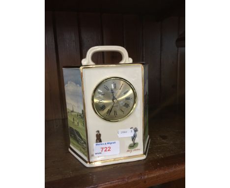 A mantel clock showing a golf scene 