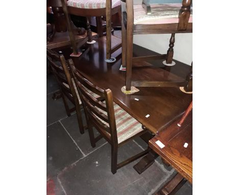 An oak dining table with carved bulbous legs and 6 ladder back chairs 