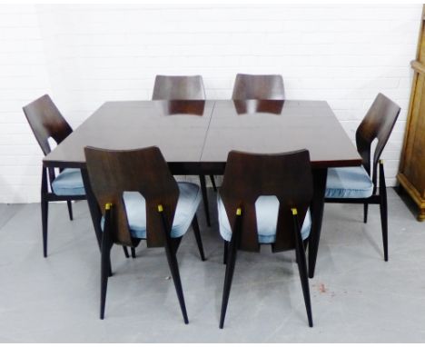 A retro Meredew dining suite comprising a set of six dining chairs with shaped backs and blue upholstered seats and tapering 