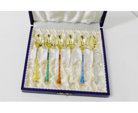 A cased set of six Danish silver gilt and coloured enamel harlequin spoons, in fitted box