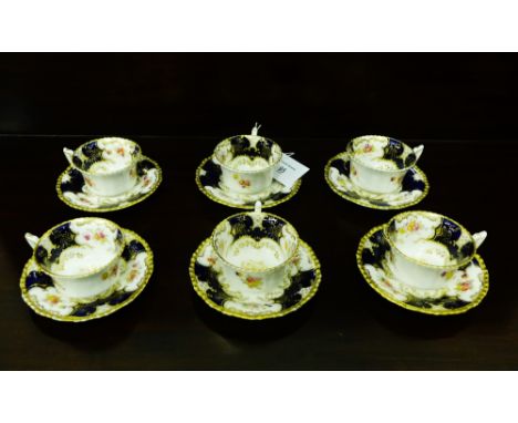 Coalport porcelain tea wares to include six cups, six saucers, with blue and gilded reserves and floral sprays, (12)