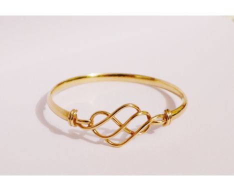 A 9 carat gold Celtic bangle