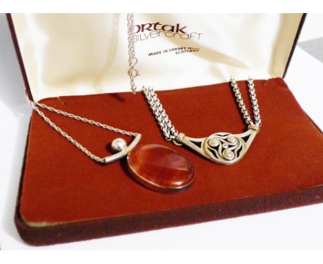 An Ola Gorie, Edinburgh silver Celtic pendant on a double silver chain, together with a Scottish silver and polished hardston
