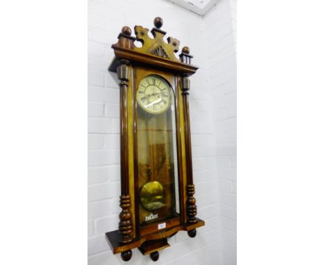 A mahogany cased Vienna wall clock with enamel dial and Roman numerals, with pendulum and double weights