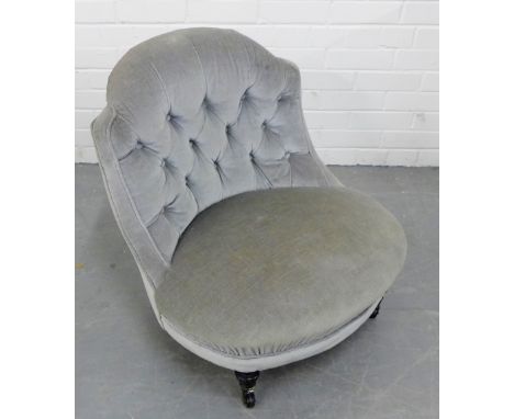 An upholstered button back bedroom chair with brass castors, 64 x 60cm