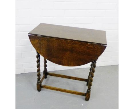 An oak drop leaf table on barley twist supports, 64 x 62cm