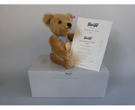 Steiff Teddy Bear of the Year 2016 with beige mohair, gold plated pendant, blue ribbon and jointed limbs, limited edition 415