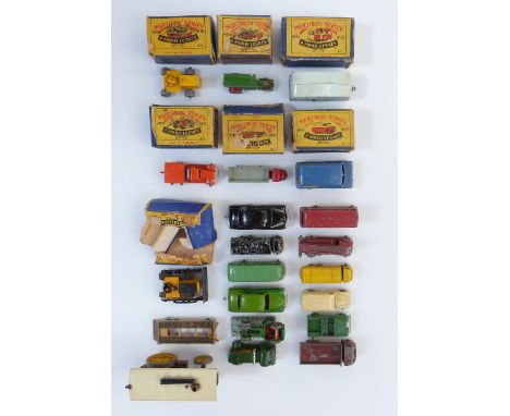 Twenty-one Moko Lesney Matchbox diecast model vehicles, seven in original boxes. 