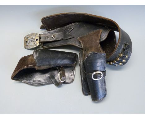 Two brown leather pistol / revolver holsters and a matching belt with dummy ammunition