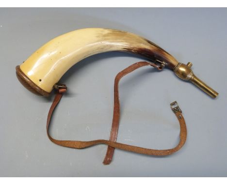 A horn powder flask with brass mounts and leather sling. 