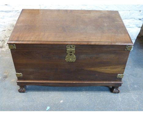 A hardwood travelling trunk raised on ball and claw feet with brass fittings W96 x D55.5 x H60cm
