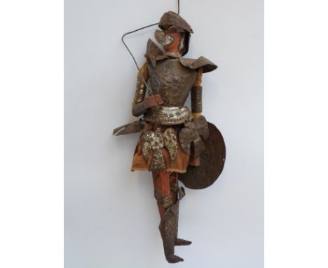 An early 20thC Japanese style tin and wooden marionette puppet with ceramic head, dressed in armour and holding a sword