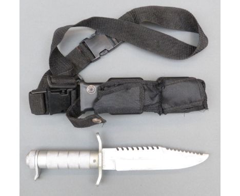 A modern diver's knife with serrated back blade marked stainless rostfrei, knurled handle with survival kit within, in scabba