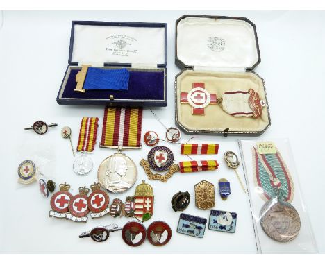 A collection of enamelled Red Cross badges, hallmarked and enamel Blood Donor badge together with a Voluntary Medical Service