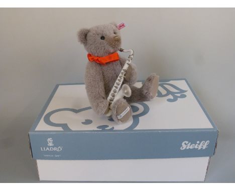 Steiff for Lladro musical teddy bear with grey mohair, ceramic saxophone, red ribbon, musical box playing Pink Panther and jo