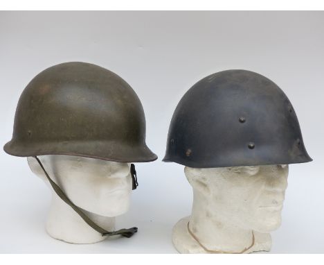 Post WWII German helmet complete with liner and chin strap together with a light weight helmet 