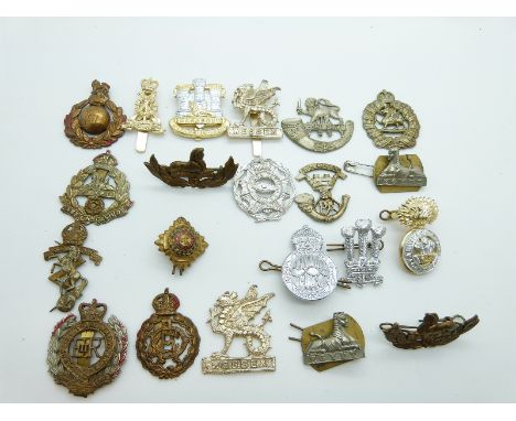 A small collection of cap badges including Herefordshire Light Infantry