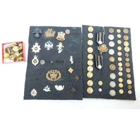 A collection of military cap badges and buttons including Navy, Royal Air Force and Army, East Yorkshire, Devonshire, Light I