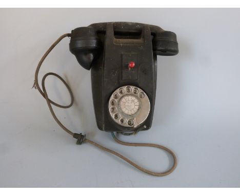 A vintage wall mounted telephone 
