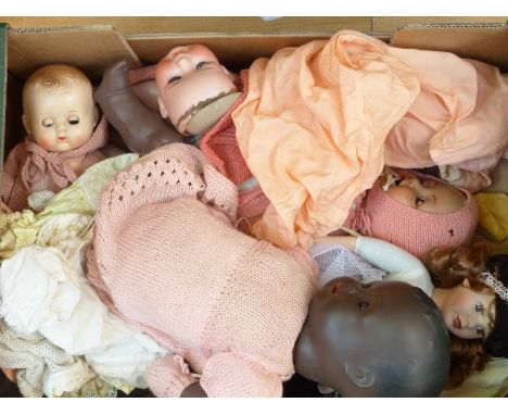 A collection of vintage dolls to include a Heubach Koppelsdorf example, and some clothing