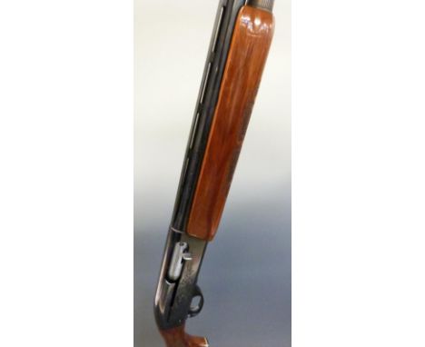 Remington model 1100 12 bore semi-automatic shotgun with ornately carved semi-pistol grip and forend, engraved lock, vented t