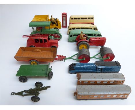 Sixteen Dinky Toys diecast model commercial vehicles including a train and coaches, fire engine, farm vehicles, telephone box