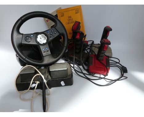A collection of Commodore and similar vintage video games together with various accessories including joystick and steering w