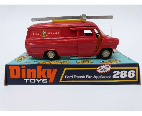 Dinky Toys diecast model Ford Transit Fire Appliance with red body, yellow interior, silver roof ladder and spun hubs 286, in