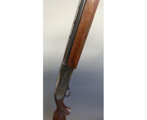 Remington model 1100 12 bore semi-automatic shotgun with ornately carved semi-pistol grip and forend, engraved lock, vented t