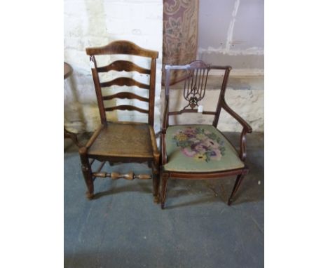 A late 19thC inlaid mahogany armchair and a ountry ladder back chair 