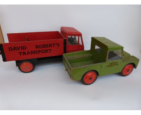 Two large scale wooden models of a Land Rover the other of a vintage lorry, both named David Roberts Transport 