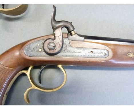 A pair of percussion hammer action pistols with chequered grip, ornate engraving to the locks, spurred brass trigger guard, b