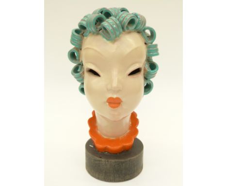 A pottery female bust on wooden plinth, probably Goldscheider, 25cm tall 