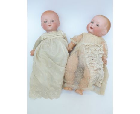 Two Armand Marseille bisque headed dolls one with open mouth, weighted brown eyes, moulded hair and jointed composite body, m