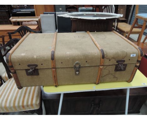 A vintage cloth bound travel trunk