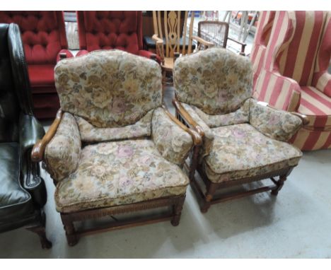 A pair of  modern Ercol mid stain upholstered armchairs